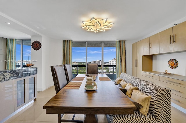 tiled dining room with floor to ceiling windows