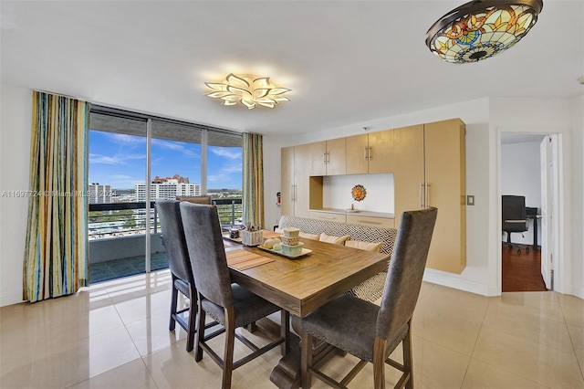 dining space with expansive windows and light tile patterned floors