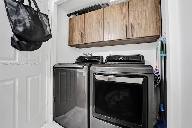 laundry area featuring cabinets and separate washer and dryer