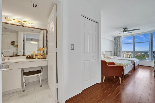 bedroom with hardwood / wood-style floors and ceiling fan