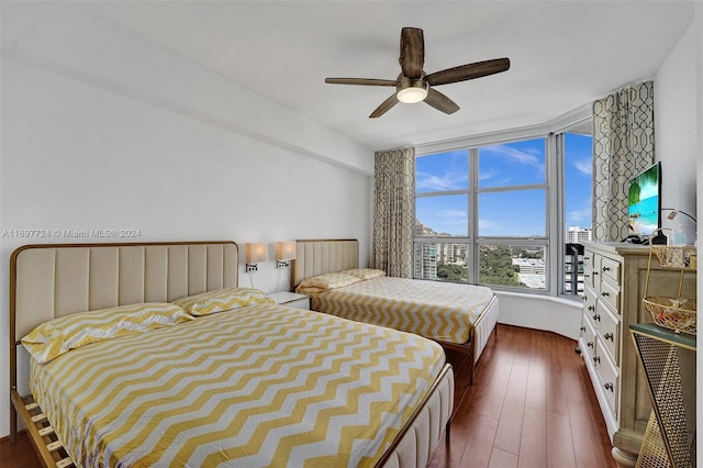 bedroom featuring ceiling fan and dark hardwood / wood-style flooring