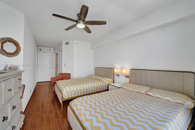 bedroom with ceiling fan and dark hardwood / wood-style flooring