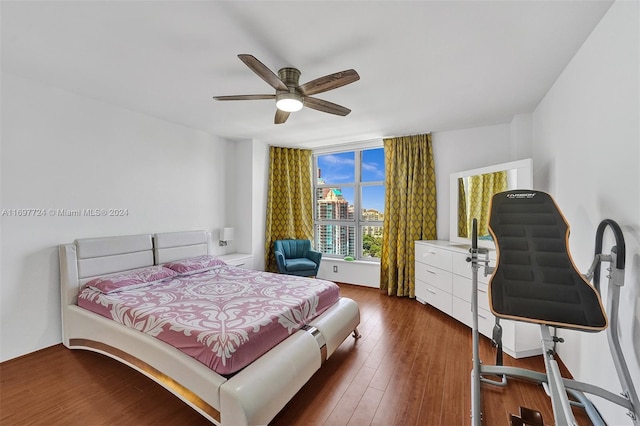 bedroom with ceiling fan and dark hardwood / wood-style flooring