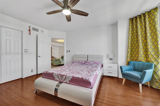 bedroom with ceiling fan and hardwood / wood-style flooring