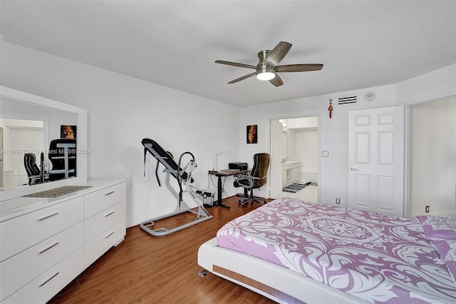 bedroom featuring hardwood / wood-style floors, ensuite bath, and ceiling fan