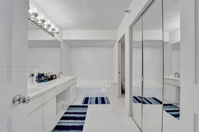 bathroom featuring tile patterned floors, vanity, and a bathing tub