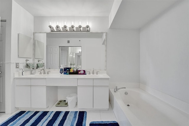 bathroom with tile patterned floors, a bathtub, and vanity