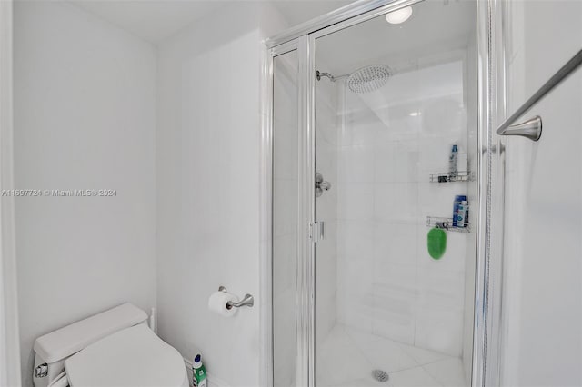 bathroom featuring toilet and walk in shower