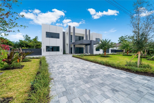 contemporary home featuring a front lawn