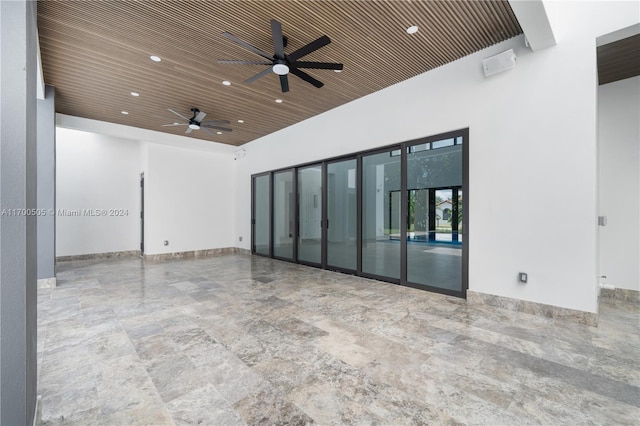 empty room with ceiling fan and wood ceiling