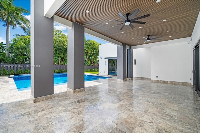 view of pool with ceiling fan and a patio