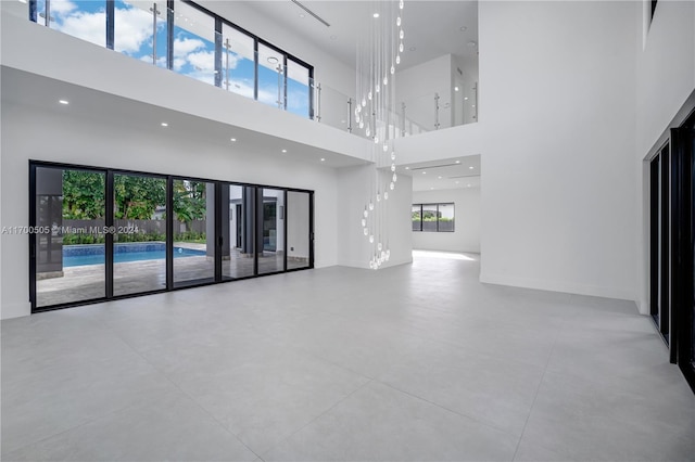 unfurnished living room with a towering ceiling