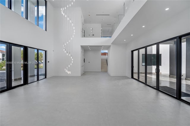 spare room featuring a towering ceiling