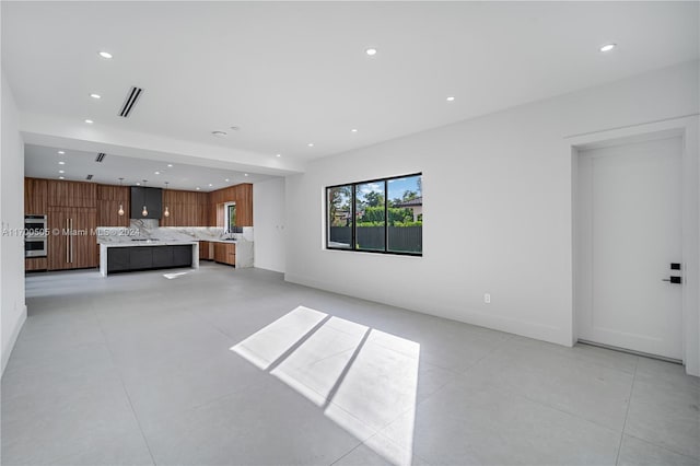 unfurnished living room with light tile patterned floors