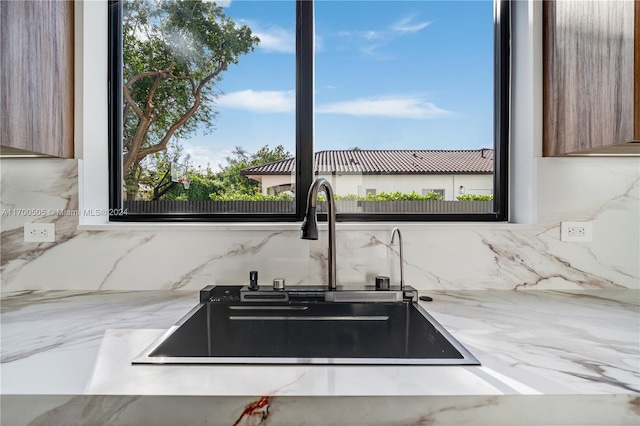 kitchen featuring backsplash and sink