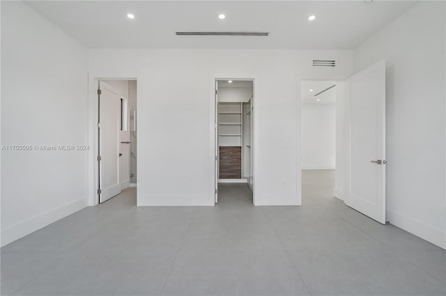 unfurnished bedroom featuring a spacious closet