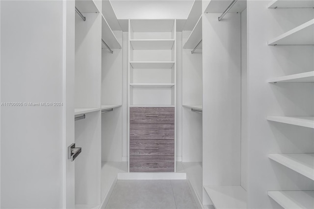 walk in closet with light tile patterned flooring