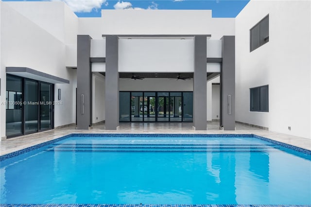 view of swimming pool featuring ceiling fan