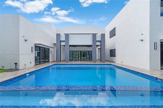 view of pool featuring ceiling fan and a patio