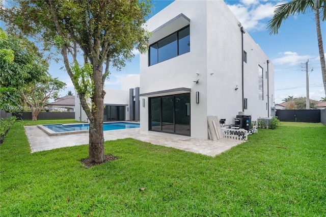 back of house with a yard, a fenced in pool, a patio area, and central air condition unit