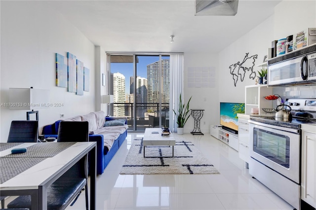 living room featuring floor to ceiling windows and light tile patterned floors