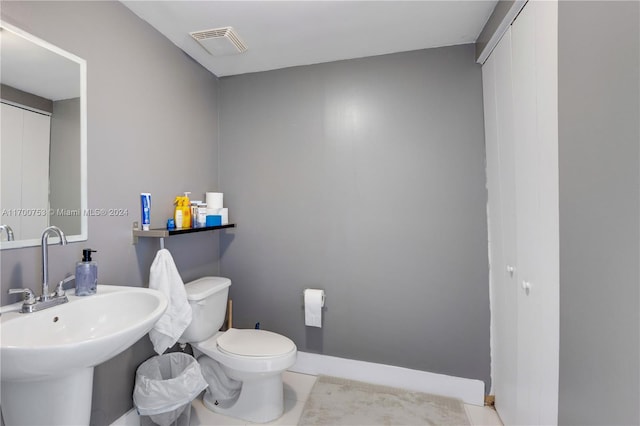 bathroom with tile patterned floors, toilet, and sink