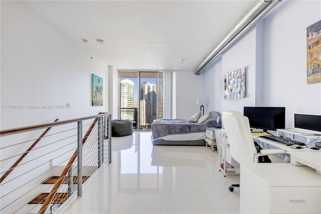 tiled bedroom featuring access to exterior and a wall of windows