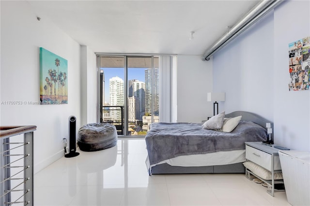 tiled bedroom featuring expansive windows and access to outside