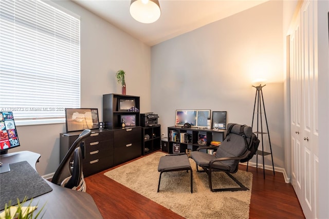 office space with lofted ceiling and dark wood-type flooring