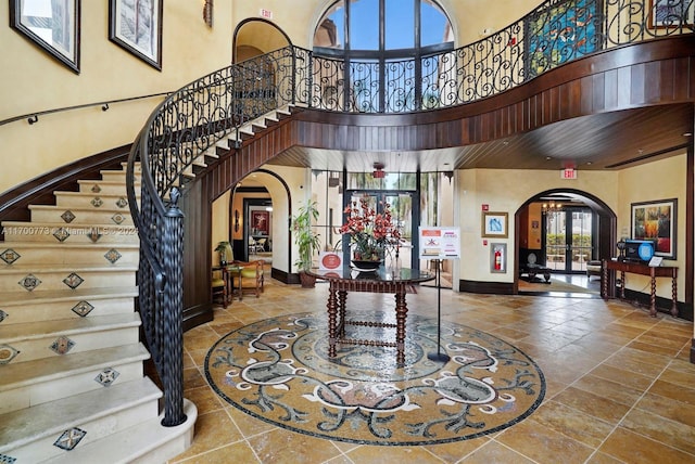 foyer featuring french doors and a high ceiling