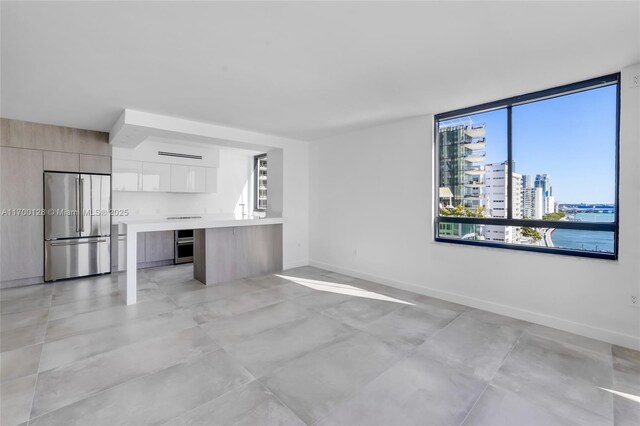 empty room with a water view and expansive windows