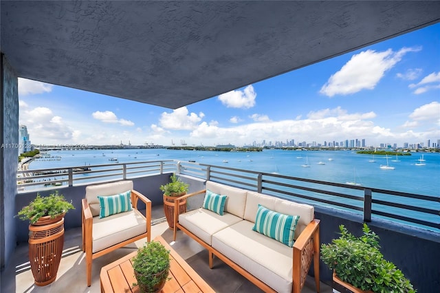 balcony featuring a water view and an outdoor hangout area