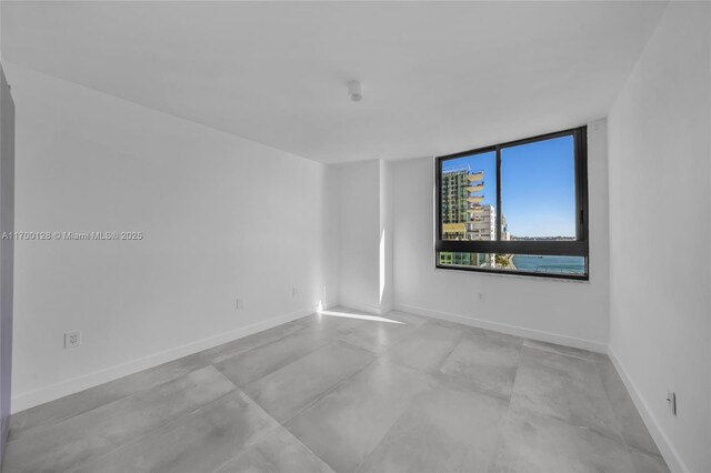 kitchen featuring stainless steel appliances, white cabinetry, plenty of natural light, and beverage cooler