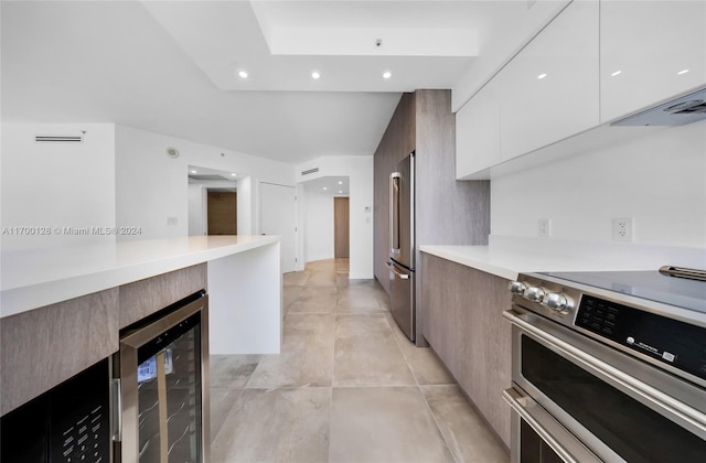 kitchen with white cabinetry, stainless steel appliances, and wine cooler