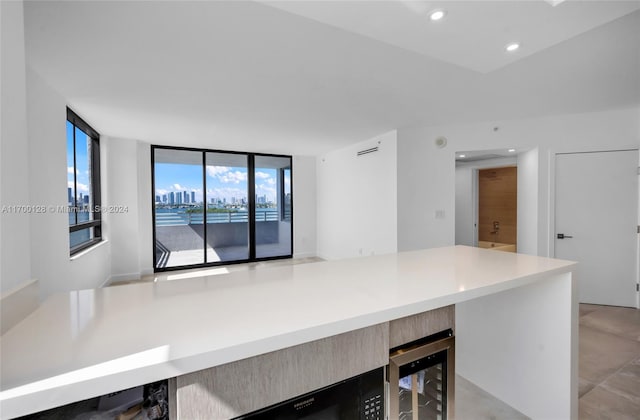 kitchen featuring plenty of natural light and beverage cooler