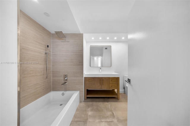 bathroom featuring vanity, tile patterned floors, and tiled shower / bath