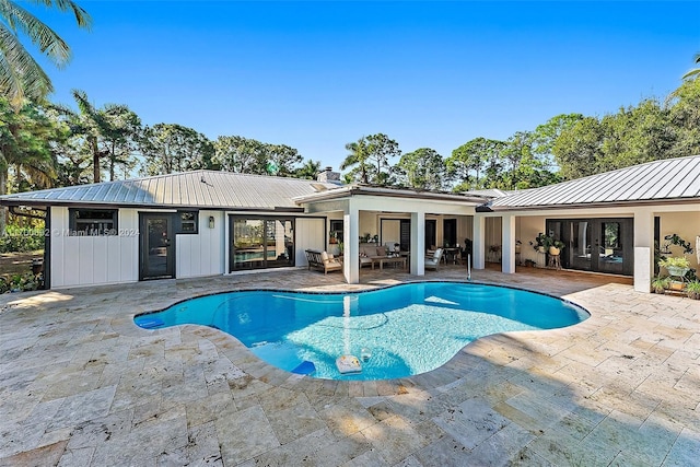 view of swimming pool with french doors, an outdoor hangout area, and a patio area