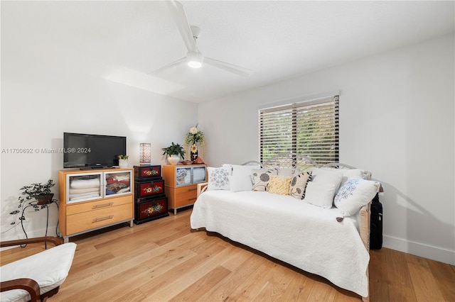 bedroom with ceiling fan and light hardwood / wood-style floors