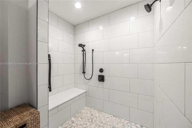 bathroom with tiled shower