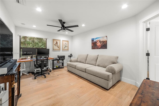 home office with ceiling fan and light hardwood / wood-style floors