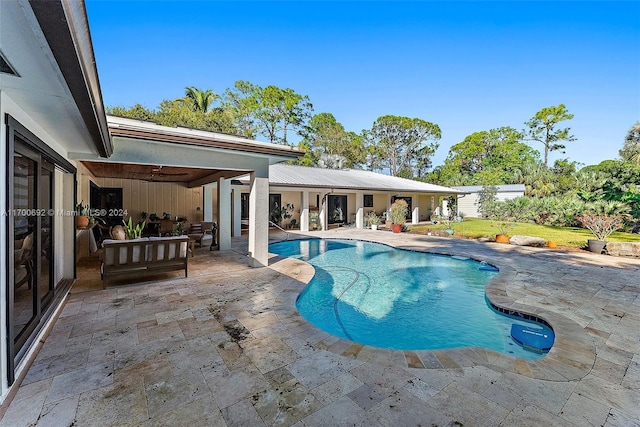 view of pool with an outdoor living space and a patio area