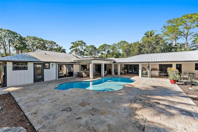 view of pool with a patio area and grilling area