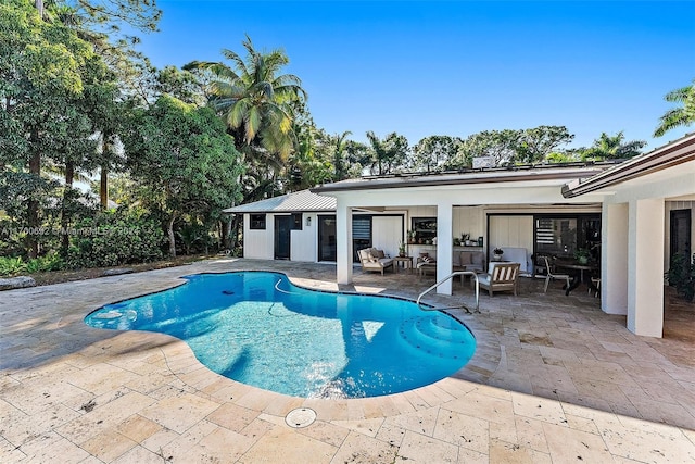 view of swimming pool with outdoor lounge area and a patio