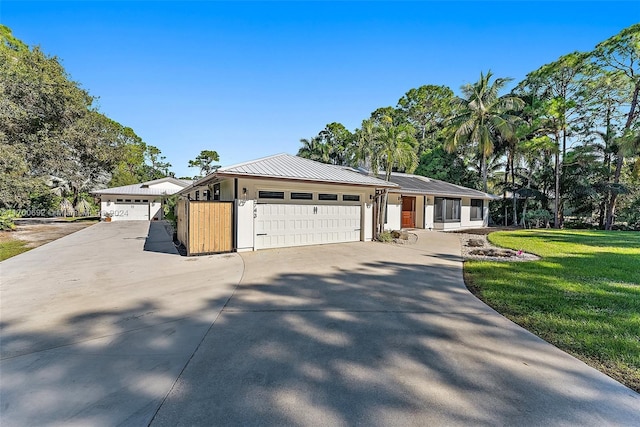 ranch-style house featuring a front yard and a garage