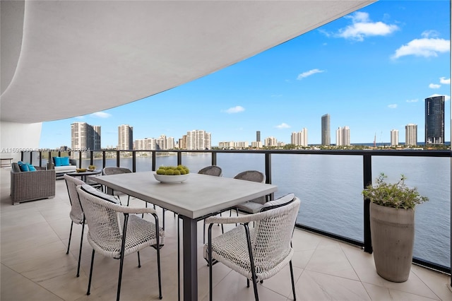 view of patio with outdoor lounge area, a water view, and a balcony