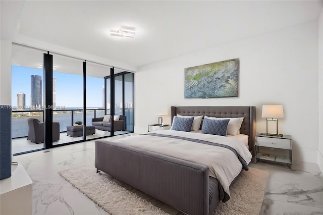 bedroom with floor to ceiling windows and a water view