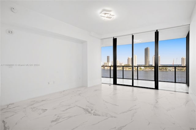 empty room with expansive windows and a water view