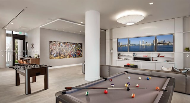 playroom with a water view, billiards, and light wood-type flooring