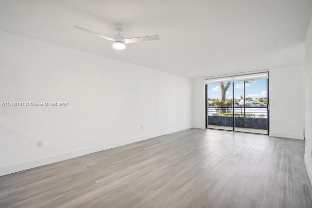 empty room featuring ceiling fan and light wood-type flooring