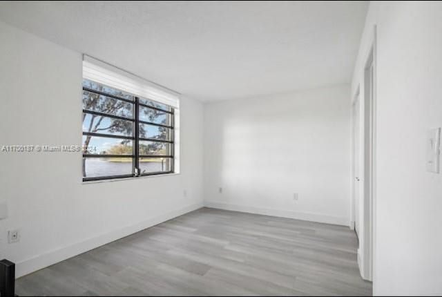 unfurnished room with light wood-type flooring